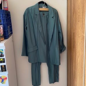 Teal powersuit with tags, both pants and blazer